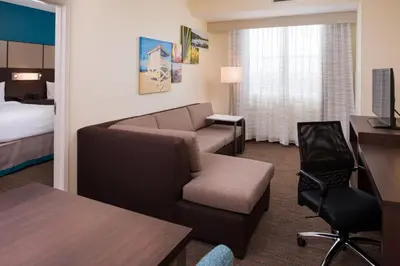 a hotel room with a couch chair and a bed at Residence Inn by Marriott Miami West/FL Turnpike in Miami