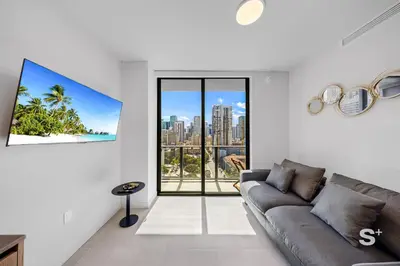 a living room with a couch and a large window at Downtown Miami - Luxury Condo with City Views in Miami