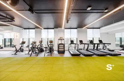a gym with several treadmills and bikes in it at Downtown Miami - Luxury Condo with City Views in Miami