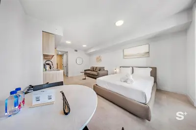 a bedroom with a bed and a table and a couch at Cozy and Spacious Studio in Miami City Views in Miami