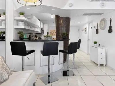 a kitchen with black bar stools in a room at Miami Beach Studio with shared Heated Pool & Gym in Miami Beach