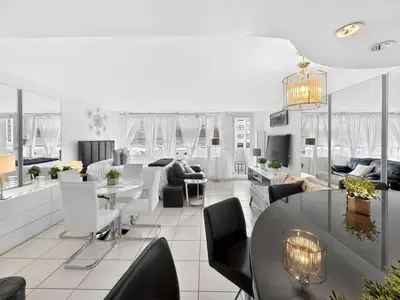 a living room with a table and chairs at Miami Beach Studio with shared Heated Pool & Gym in Miami Beach