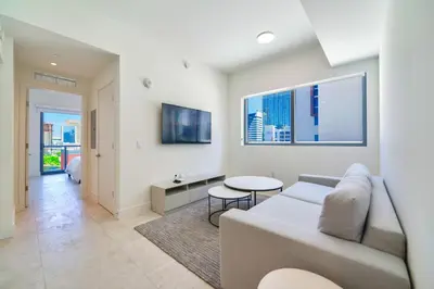 a living room with a couch and a table at Modern Escape in Brickell w Pool & Gym in Miami