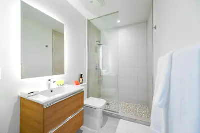 a bathroom with a toilet and a sink and a shower at Modern Escape in Brickell w Pool & Gym in Miami