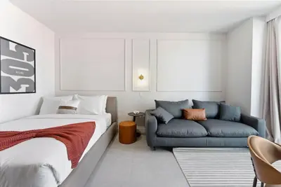 a bedroom with a bed and a couch at 501 First Residences in Miami