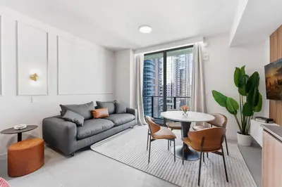 a living room with a couch and a table at 501 First Residences in Miami