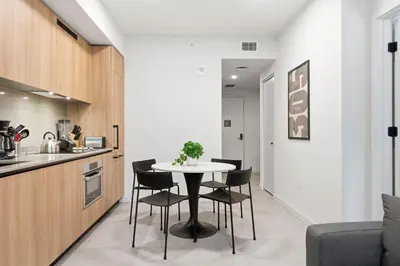 a kitchen and dining room with a table and chairs at 501 First Residences in Miami