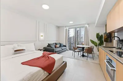 a bedroom with a large bed and a living room at 501 First Residences in Miami