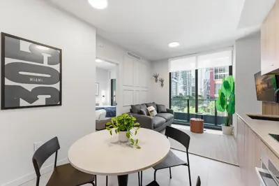 a living room with a table and chairs and a couch at 501 First Residences in Miami