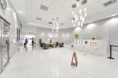 a lobby with white tile floors and chandeliers at Bright Escape Near Hot Spots in Miami