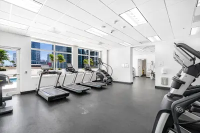 a gym with cardio equipment in a building at Bright Escape Near Hot Spots in Miami