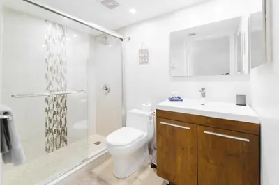 a bathroom with a toilet and a shower and a sink at Bright Escape Near Hot Spots in Miami