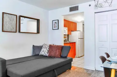 a living room with a couch and a kitchen at Studio W Panoramic Views Prime Comfort in Miami