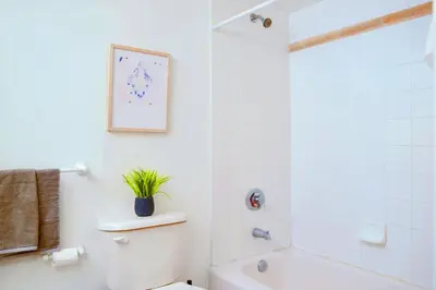 a white bathroom with a toilet and a shower at Studio W Panoramic Views Prime Comfort in Miami