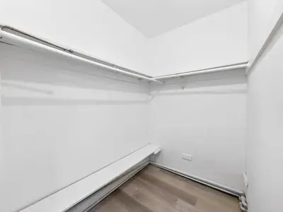 an empty room with white walls and a wooden floor at Cozy Miami Beach Studio with 2 Queens plus Workspace in Miami Beach