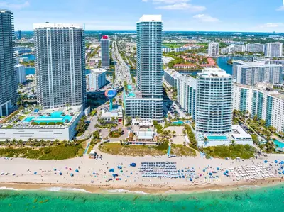 an aerial view of a beach in front of a city at Modern Beachside Condo W Ocean Views in Hollywood