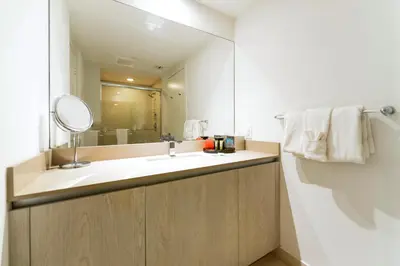a bathroom with a sink and a mirror at Modern Beachside Condo W Ocean Views in Hollywood