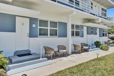 a porch of a house with chairs and a door at Oceanfront Residence by Atlantikos in Hollywood