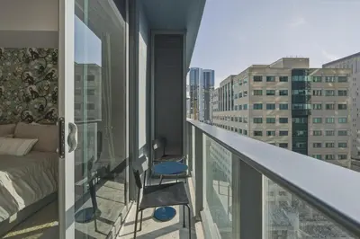 a room with a bed and a chair on a balcony at New Luxury Studio Downtown Miami Prime Location in Miami