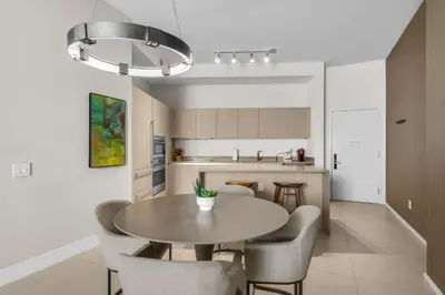 a kitchen with a table and chairs in a room at Lyfe Resort Ocean View Gym Direct Beach Access in Hollywood