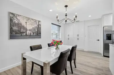 a white dining room with a white table and chairs at Spacious 3BR Home with Private Pool in Hollywood in Hollywood