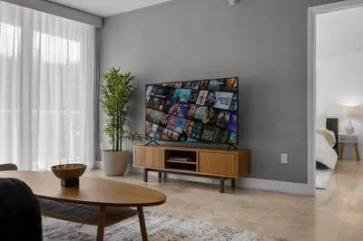 a living room with a flat screen tv on a wall at The Palazzo, Heart of Miami, Rooftop Pool, Lux Spa in Miami