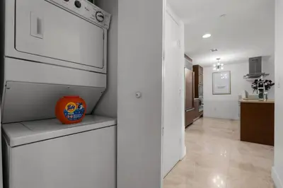 a kitchen with an orange vase sitting on a shelf at The Palazzo, Heart of Miami, Rooftop Pool, Lux Spa in Miami