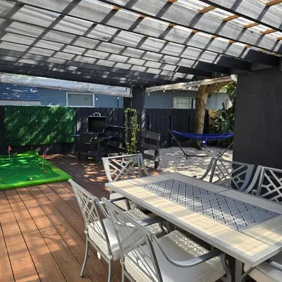 a patio with a table and chairs under a pergola at Cozy private 2BR Home with Outdoor space and BBQ grill in Hollywood