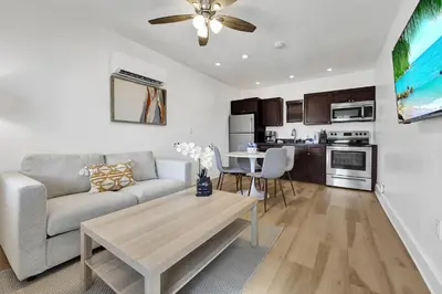 a living room with a couch and a table at Walnut Beach - By Atlantikos in Hollywood