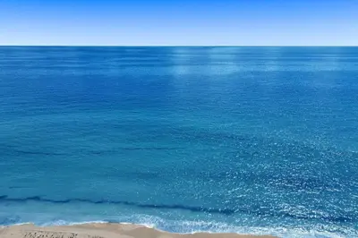 a large body of blue water with a beach at Desoto Beach Retreat with Heated Pool - By Atlantikos in Hollywood