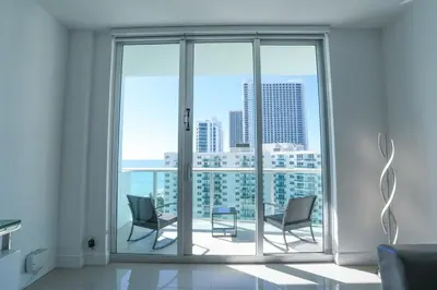 a living room with two chairs and a large window at The Tides on Hollywood Beach in Hollywood