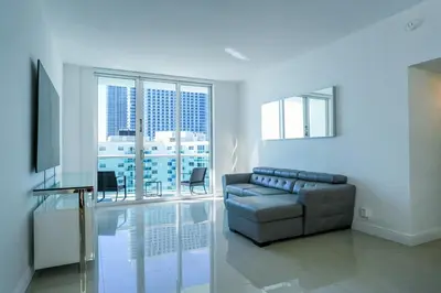 a living room with a couch and a television at The Tides on Hollywood Beach in Hollywood