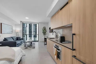 a kitchen and living room with a bed and a couch at Brand New Modern Downtown Studio at Prime Location in Miami