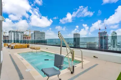 a swimming pool on the roof of a building at Free Parking Downtown Condo Resort Amenities in Miami