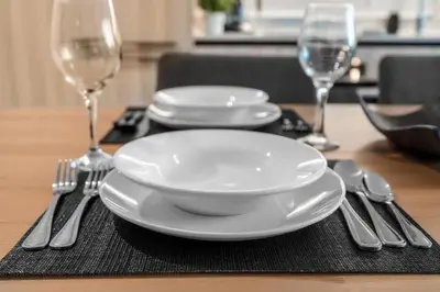 a table with two plates and silverware on a table at Free Parking Downtown Condo Resort Amenities in Miami