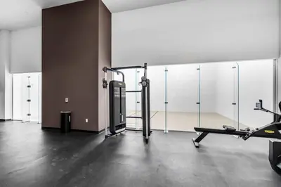 a room with a gym with a treadmill and glass walls at Free Parking Downtown Condo Resort Amenities in Miami
