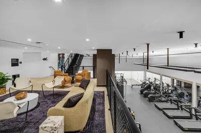a lobby with couches and chairs and stairs at Free Parking Downtown Condo Resort Amenities in Miami