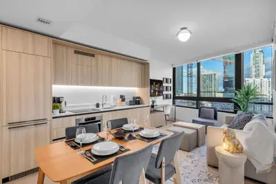 a kitchen and living room with a table and chairs at Free Parking Downtown Condo Resort Amenities in Miami