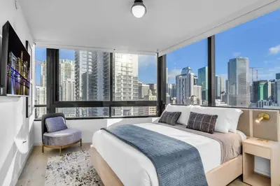 a bedroom with a large bed and a large window at Free Parking Downtown Condo with Resort Amenities in Miami