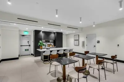 a room with tables and chairs and a kitchen at Free Parking Downtown Condo with Resort Amenities in Miami