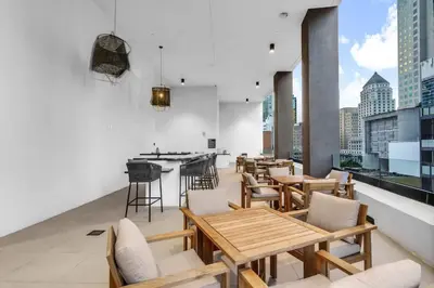 a restaurant with tables and chairs on a balcony at Free Parking Downtown Condo with Resort Amenities in Miami