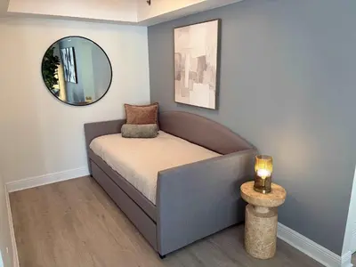 a small bed in a room with a mirror at Brickell Bayfront Oasis Stunning Views Pool Gym in Miami