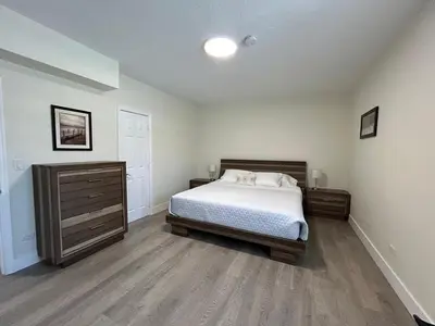 a bedroom with a bed and a dresser in it at Spring Village by the Canal Loft in Miami