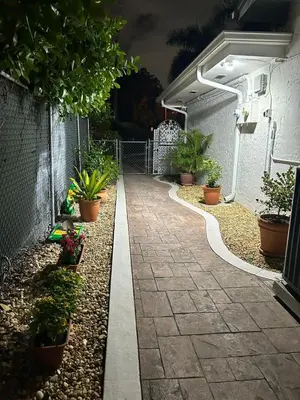 a walkway with potted plants on the side of a building at Spring Village by the Canal Loft in Miami