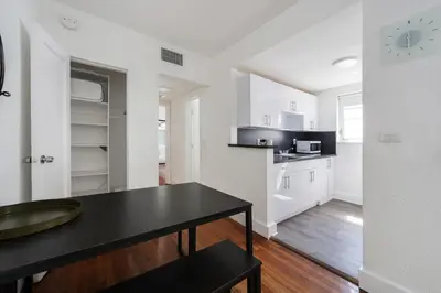 a white kitchen with a black table in a room at Alton Apts By At Mine Hospitality in Miami Beach