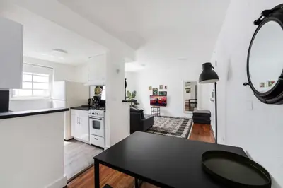 a kitchen and a living room with a black table at Alton Apts By At Mine Hospitality in Miami Beach