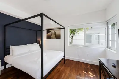 a bedroom with a black and white canopy bed at Alton Apts By At Mine Hospitality in Miami Beach