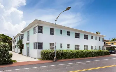 a white building on a street with a street light at Alton Apts By At Mine Hospitality in Miami Beach