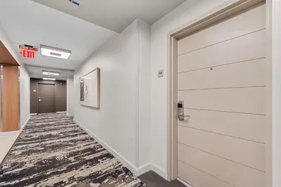 a hallway with a door in a office building at Arya Hotel & Suites in Miami