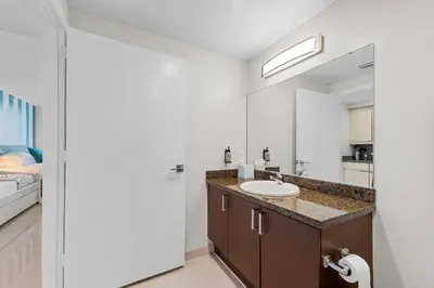 a bathroom with a sink and a mirror at Arya Hotel & Suites in Miami